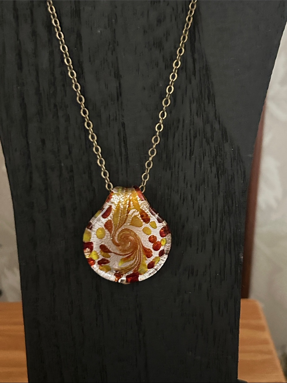 Bronze, silver, and gold town, glass pendant, and bronze chain